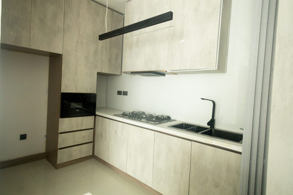 Brum Height 6: Kitchen worktop and hob beneath fitted wall cabinets